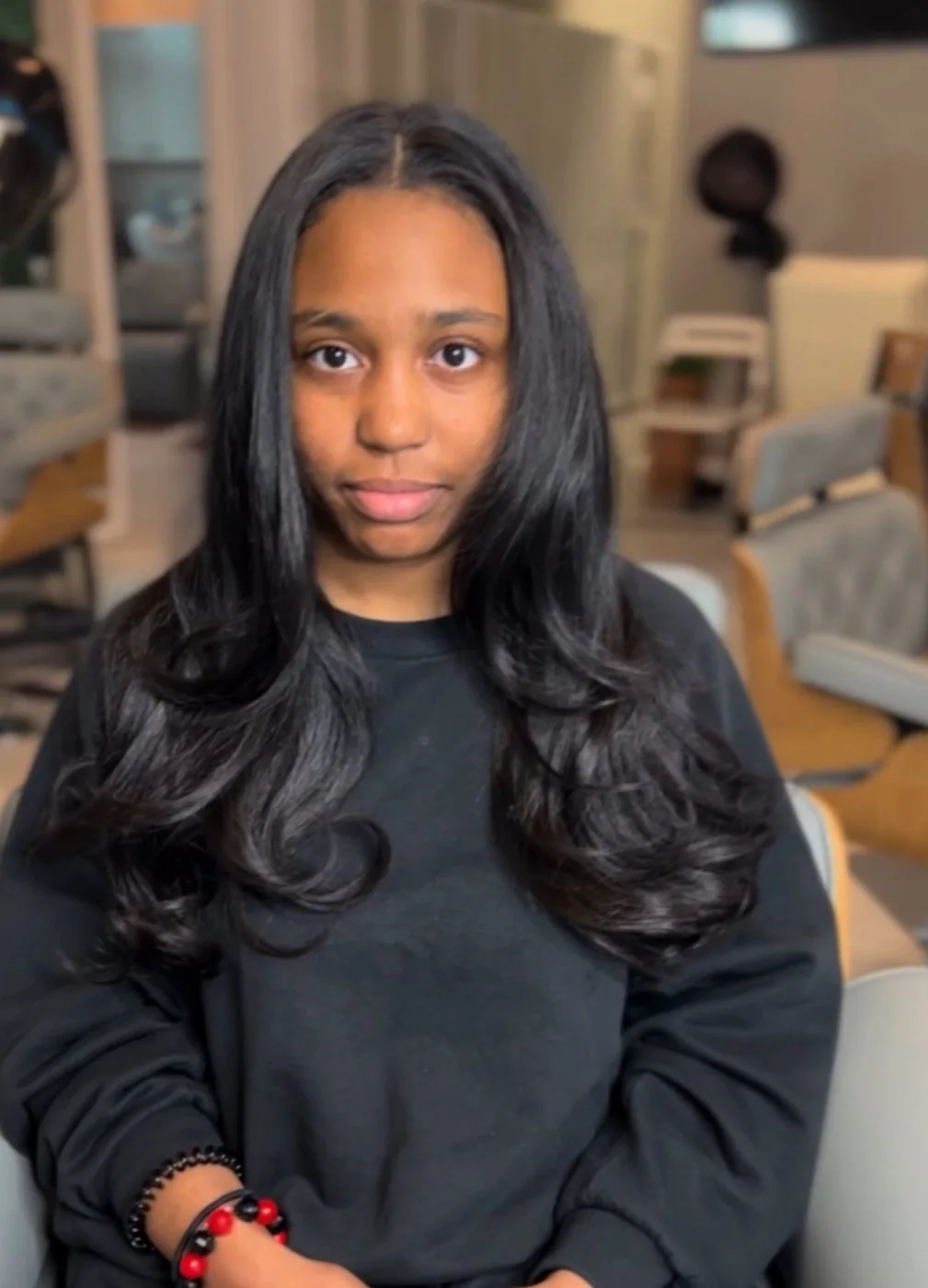Silk press on natural textured hair with smooth roots and polished ends in Dallas, Texas.